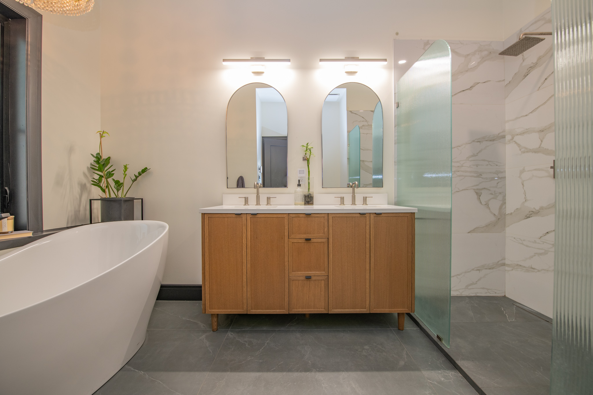 Double vanity with arched mirrors and premium fixtures
